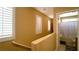 Upstairs hallway with white shutters on the windows and neutral colored walls; bathroom is visible at the end of the hallway at 1300 Sand Castle Ave, Las Vegas, NV 89183