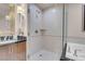 A full bathroom featuring a double sink vanity and walk-in glass shower at 135 E Harmon Ave # 2601&2603, Las Vegas, NV 89109