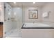 Bright bathroom with a glass-enclosed shower, and a soaking tub for ultimate relaxation at 135 E Harmon Ave # 2601&2603, Las Vegas, NV 89109