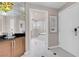 Hallway with storage leading to a bathroom featuring white-tiled floors and a shower at 135 E Harmon Ave # 2601&2603, Las Vegas, NV 89109