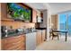 Kitchenette featuring wood cabinets, and a sleek black countertop, next to a comfortable sleeping area at 135 E Harmon Ave # 2601&2603, Las Vegas, NV 89109