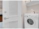 Convenient laundry room with a modern washing machine and ample shelving for storage at 135 E Harmon Ave # 2601&2603, Las Vegas, NV 89109