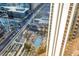 A bird's eye view of a resort with a pool, palm trees, and city views at 135 E Harmon Ave # 2601&2603, Las Vegas, NV 89109