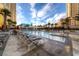 Beautiful outdoor pool area with lounge chairs and palm trees surrounded by Las Vegas high rise buildings at 135 E Harmon Ave # 2601&2603, Las Vegas, NV 89109