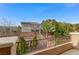 Backyard view from a raised patio area, overlooking lush landscaping and mature trees at 1381 Robard St, Las Vegas, NV 89135