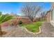 Beautiful backyard with well-maintained lawn and decorative stone landscaping at 1381 Robard St, Las Vegas, NV 89135