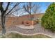 The backyard features a brick fire pit, trees and decorative landscaping at 1381 Robard St, Las Vegas, NV 89135