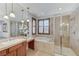 Bright bathroom featuring double vanities, a soaking tub, and a glass enclosed shower at 1381 Robard St, Las Vegas, NV 89135