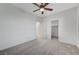 A bedroom with neutral walls, ceiling fan, carpeted floor, and walk-in closet for ample storage at 1381 Robard St, Las Vegas, NV 89135