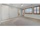 Spacious bedroom featuring neutral carpeting, a ceiling fan, and windows with wood shutters at 1381 Robard St, Las Vegas, NV 89135