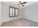 Bedroom features neutral carpet, a ceiling fan, and shuttered windows at 1381 Robard St, Las Vegas, NV 89135