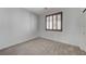 Empty bedroom featuring a window with wood shutters and neutral-toned carpeting at 1381 Robard St, Las Vegas, NV 89135