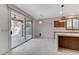 Bright dining area with tile floors, modern pendant lights, access to the patio, and stainless steel appliances at 1381 Robard St, Las Vegas, NV 89135