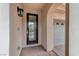 Inviting foyer featuring a dark wood door with decorative glass and tan walls at 1381 Robard St, Las Vegas, NV 89135