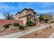 Charming two-story home featuring stucco exterior, tile roof, mature landscaping, and a sidewalk at 1381 Robard St, Las Vegas, NV 89135