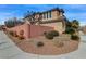 Charming two-story home featuring stucco exterior, tile roof, desert landscaping, and mature trees at 1381 Robard St, Las Vegas, NV 89135