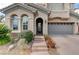 Inviting front entrance with an arched doorway, a decorative glass door, and a paved walkway at 1381 Robard St, Las Vegas, NV 89135