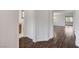 Hallway featuring dark wood floors and white walls leading into an open concept living area at 1381 Robard St, Las Vegas, NV 89135