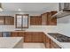 Kitchen with wooden cabinets, a stainless steel hood, and modern appliances at 1381 Robard St, Las Vegas, NV 89135