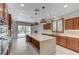 Wide angle of kitchen with wooden cabinets, stainless double oven, and large island at 1381 Robard St, Las Vegas, NV 89135