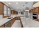 Kitchen featuring wooden cabinets, a marble island and stainless steel appliances at 1381 Robard St, Las Vegas, NV 89135