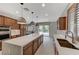 Kitchen with views of the backyard, a marble island and stainless steel appliances at 1381 Robard St, Las Vegas, NV 89135