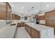 Wide angle of kitchen with stainless appliances, a large island and wooden cabinets at 1381 Robard St, Las Vegas, NV 89135