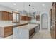 Bright kitchen with a large marble island, stainless steel appliances, and wooden cabinets at 1381 Robard St, Las Vegas, NV 89135