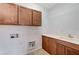 A laundry room equipped with cabinetry, a sink, and connections for a washer and dryer at 1381 Robard St, Las Vegas, NV 89135