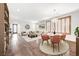 Bright, open-concept living and dining area with wood floors and stylish light fixtures at 1381 Robard St, Las Vegas, NV 89135