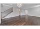 Bright living room with hardwood floors, staircase, modern lighting fixture, and arched doorways for a modern touch at 1381 Robard St, Las Vegas, NV 89135