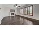 Open living room with hardwood floors, a fireplace, large windows, and recessed lighting, for a bright and airy atmosphere at 1381 Robard St, Las Vegas, NV 89135