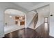 Open-concept living room with hardwood floors leading to an open kitchen, staircase, and exterior door for easy access at 1381 Robard St, Las Vegas, NV 89135