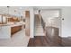 Open floor plan living room and kitchen space featuring modern cabinetry and dark wood floors at 1381 Robard St, Las Vegas, NV 89135