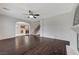 Spacious living room with dark wood floors that flows into the kitchen at 1381 Robard St, Las Vegas, NV 89135