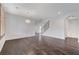 Spacious living room featuring hardwood floors, staircase, modern light fixtures, and neutral paint, creating an open space at 1381 Robard St, Las Vegas, NV 89135