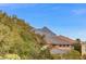 Mountain view featuring a lush tree line and a house with a clay tile roof on a sunny day, perfect for relaxing outdoors at 1381 Robard St, Las Vegas, NV 89135