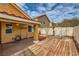 A spacious back yard showcases a cozy covered patio area with a weathered deck, offering a private outdoor retreat at 1424 Desert Hills Dr, Las Vegas, NV 89117