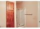 Bathroom showcasing a glass enclosed shower and a wood storage cabinet at 1424 Desert Hills Dr, Las Vegas, NV 89117