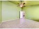 Bedroom with a ceiling fan, tile floors, plantation shutters, and a view into an adjacent kitchen at 1424 Desert Hills Dr, Las Vegas, NV 89117