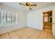 Bedroom with tile floors, ceiling fan, and plantation shutters at 1424 Desert Hills Dr, Las Vegas, NV 89117