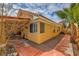 Exterior view of the home with a well-maintained yard and covered patio at 1424 Desert Hills Dr, Las Vegas, NV 89117