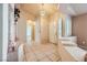 Inviting foyer with tiled flooring, decorative columns, and a view into other rooms, showcasing the home's layout at 1424 Desert Hills Dr, Las Vegas, NV 89117