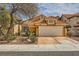 Inviting single-Gathering home with desert landscaping, a red tile roof, and an attached two-car garage in a suburban setting at 1424 Desert Hills Dr, Las Vegas, NV 89117