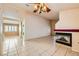 Open-concept living room with fireplace, columns, and tiled floors at 1424 Desert Hills Dr, Las Vegas, NV 89117