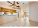 Living room open to kitchen with breakfast bar and ceiling fan at 1424 Desert Hills Dr, Las Vegas, NV 89117