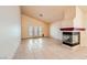 Spacious living room featuring tile floors, fireplace, and natural light from french doors, creating an inviting atmosphere at 1424 Desert Hills Dr, Las Vegas, NV 89117