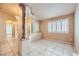 Open living room area with marble pillars, tile flooring, and natural light from large windows at 1424 Desert Hills Dr, Las Vegas, NV 89117