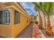 Home side yard view with mature palm trees and gravel landscaping, complementing the property's exterior design at 1424 Desert Hills Dr, Las Vegas, NV 89117