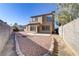 Backyard with a stone walkway, block wall, and low maintenance desert landscaping at 1444 Country Hollow Dr, Las Vegas, NV 89117